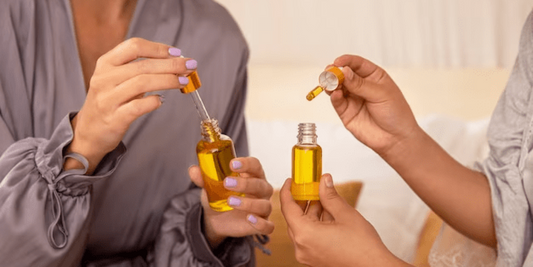 An elegant image featuring essential oil bottles surrounded by aromatic herbs, flowers, and citrus slices, highlighting the natural shine and nourishment these oils provide for radiant skin.